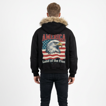 A black hooded sweatshirt shown from the back, featuring a large graphic print of an eagle head over an American flag with the words 'AMERICA' above and 'Land of the Free' below.